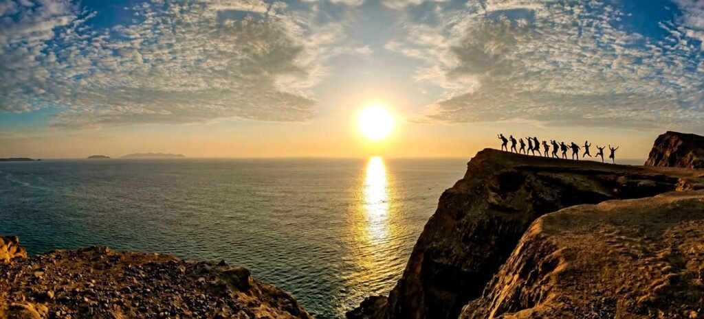 Panoramic view of Paracas National Reserve featuring dramatic coastal cliffs, Playa Roja beach, desert landscapes, and the Pacific Ocean in Peru.