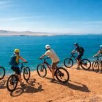 Panoramic view of Paracas National Reserve featuring dramatic coastal cliffs, Playa Roja beach, desert landscapes, and the Pacific Ocean in Peru.