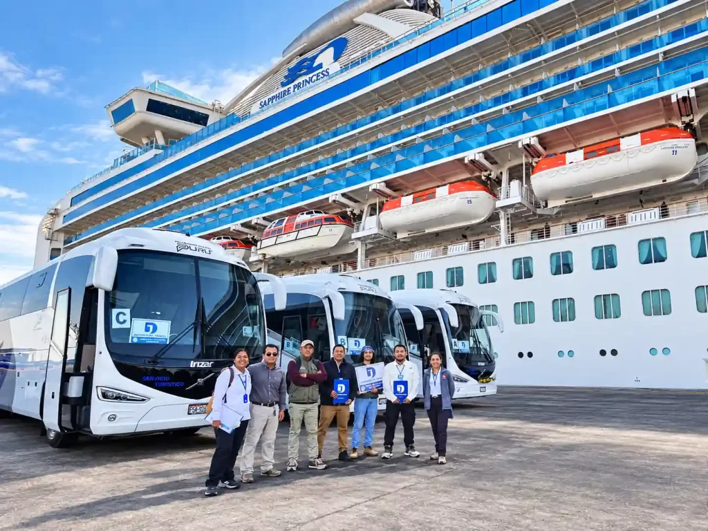 JD Adventure Travel shore excursion team and coaches beside a cruise ship